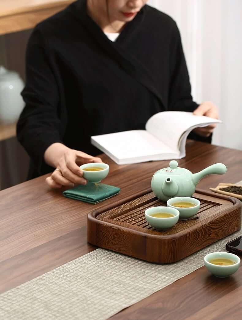 http://mokupark.com/cdn/shop/products/simple-small-wenge-wood-tea-tray-one-pot-four-cups-dry-brew-set-moku-park-1.jpg?v=1645838027